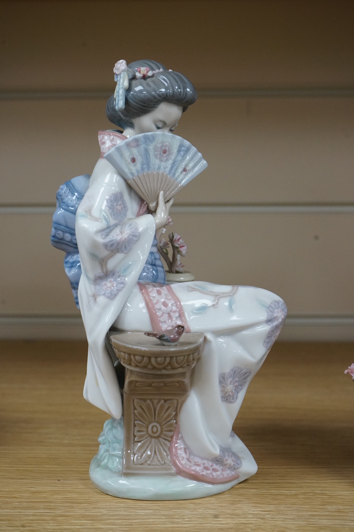 Three Lladro models of seated Geisha. Tallest 23cm